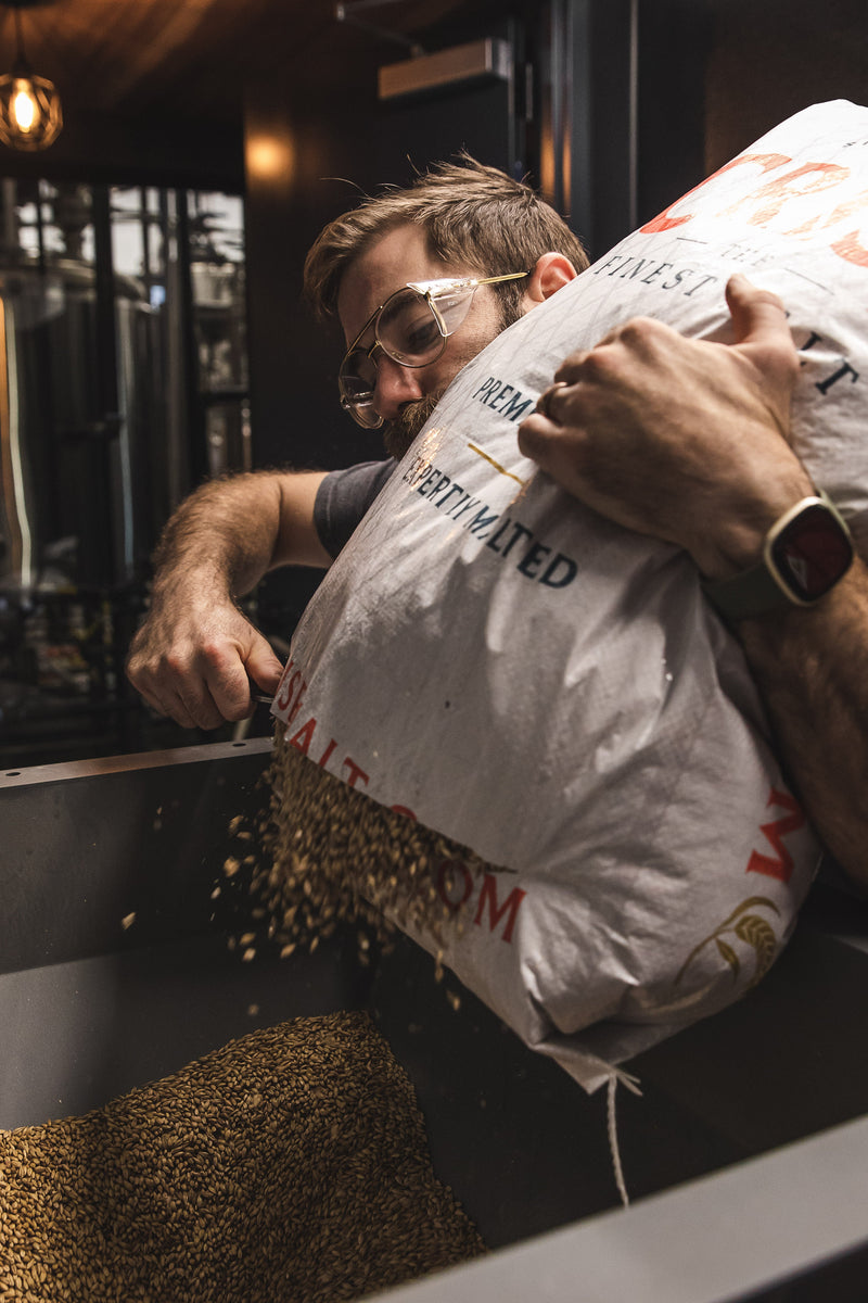 Go Brewing head brewer James Bigler adding malt to the mash