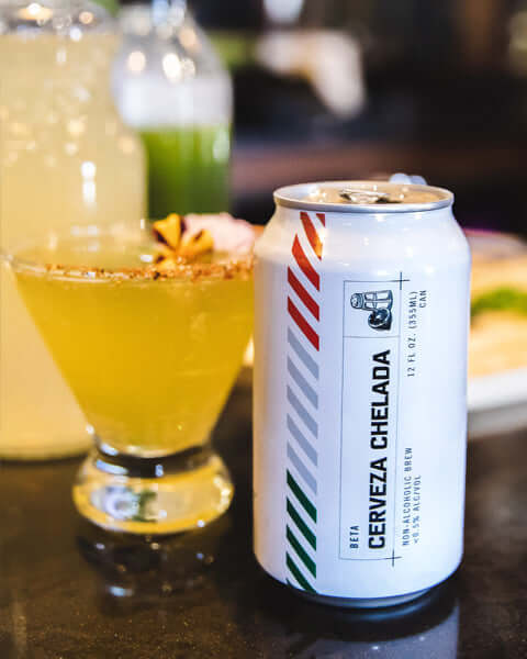 Cold lemonade pitcher, can of Cerveza Chelada, and a festive A Day in Mexico mocktail