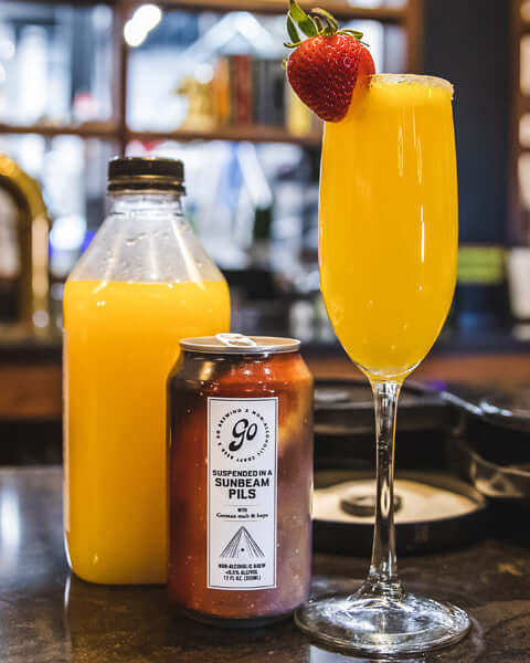 Orange juice, can of Suspended in a Sunbeam and delicious Beer for Breakfast mocktail