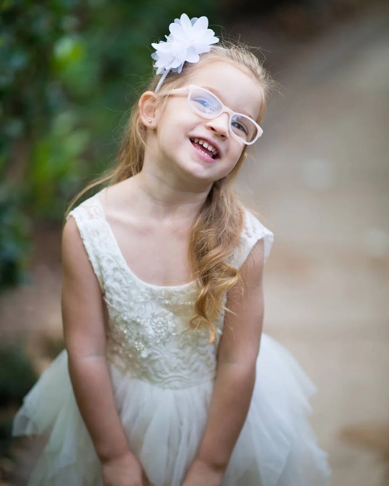 Emma smiling in a white dress