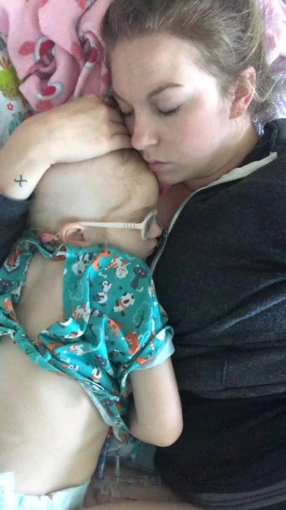Emma asleep on her mom during treatment