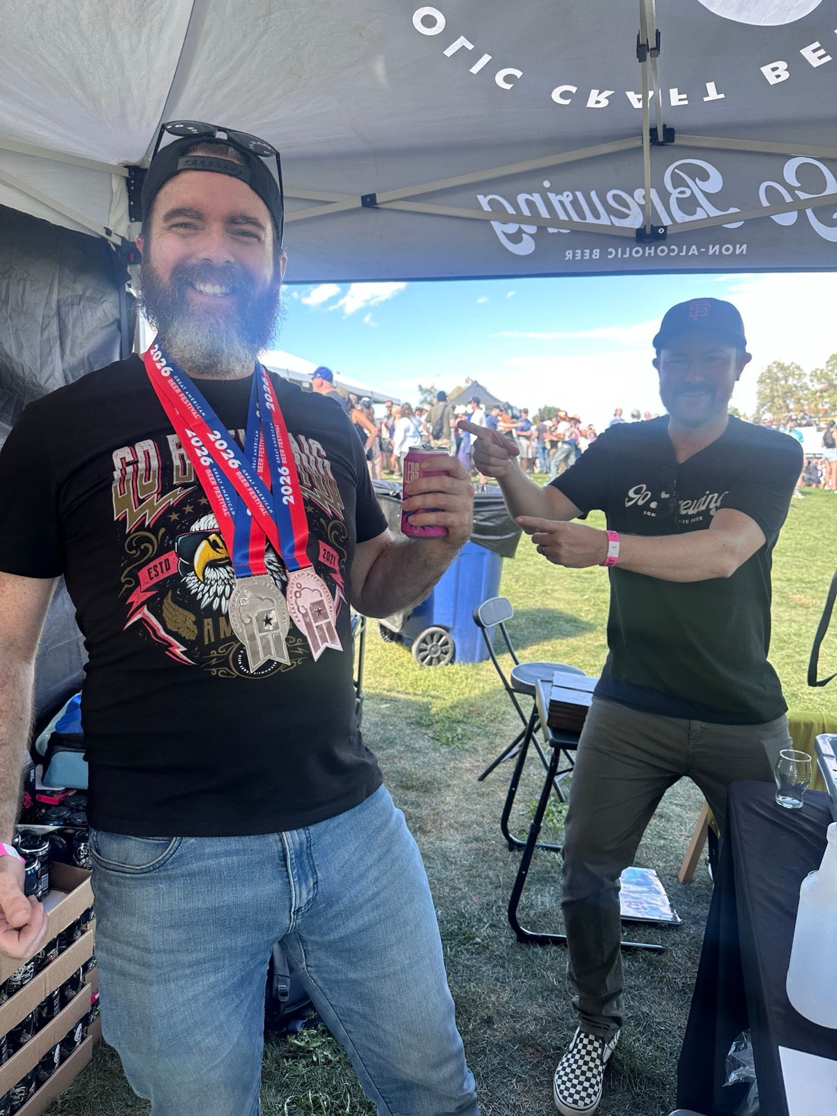 The Go Brewing team at the GABF 2026 booth wearing their silver and bronze medals